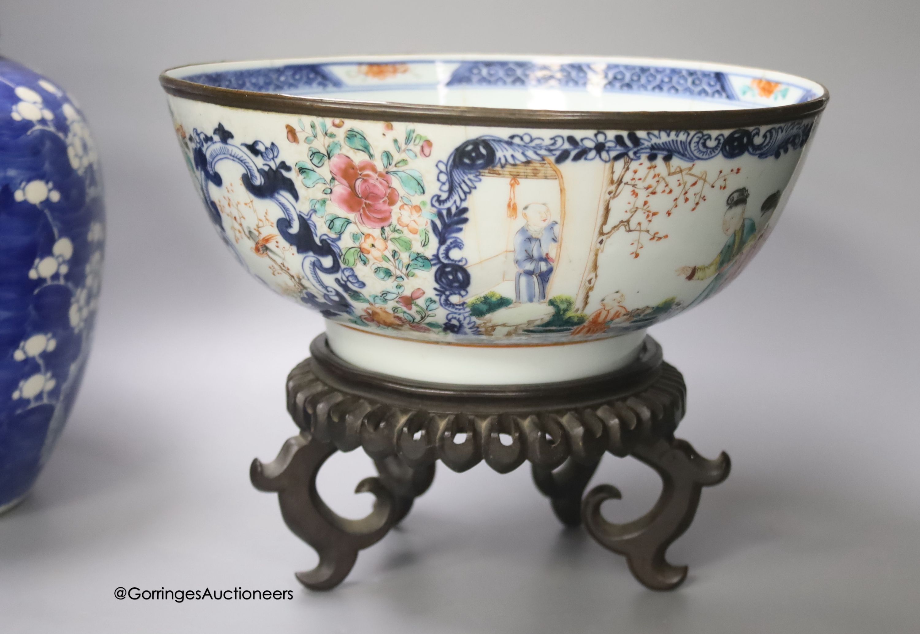 A 19th century Chinese porcelain prunus jar and cover, 27cm, on carved wood stand, a smaller famille noire jar and cover, a Chinese export fruit bowl, blue and white dish and a similar jar and cover 27cm
